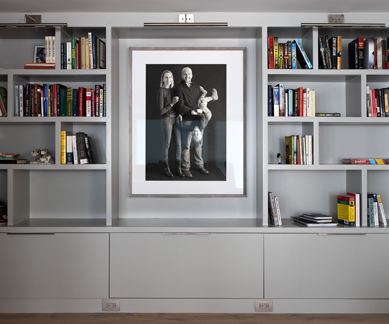 Beautifully framed fine art family portrait in a personal library