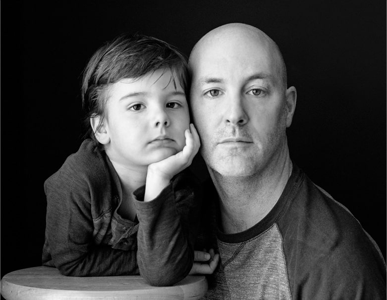 Black and white portrait of father and son close up