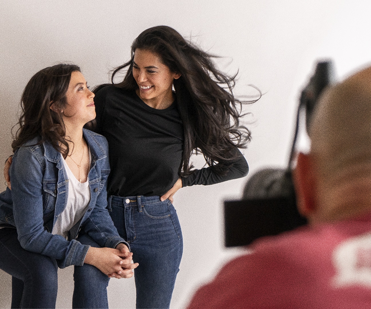 behind the scenes photo of a mom and daughter having picture taken by photographer