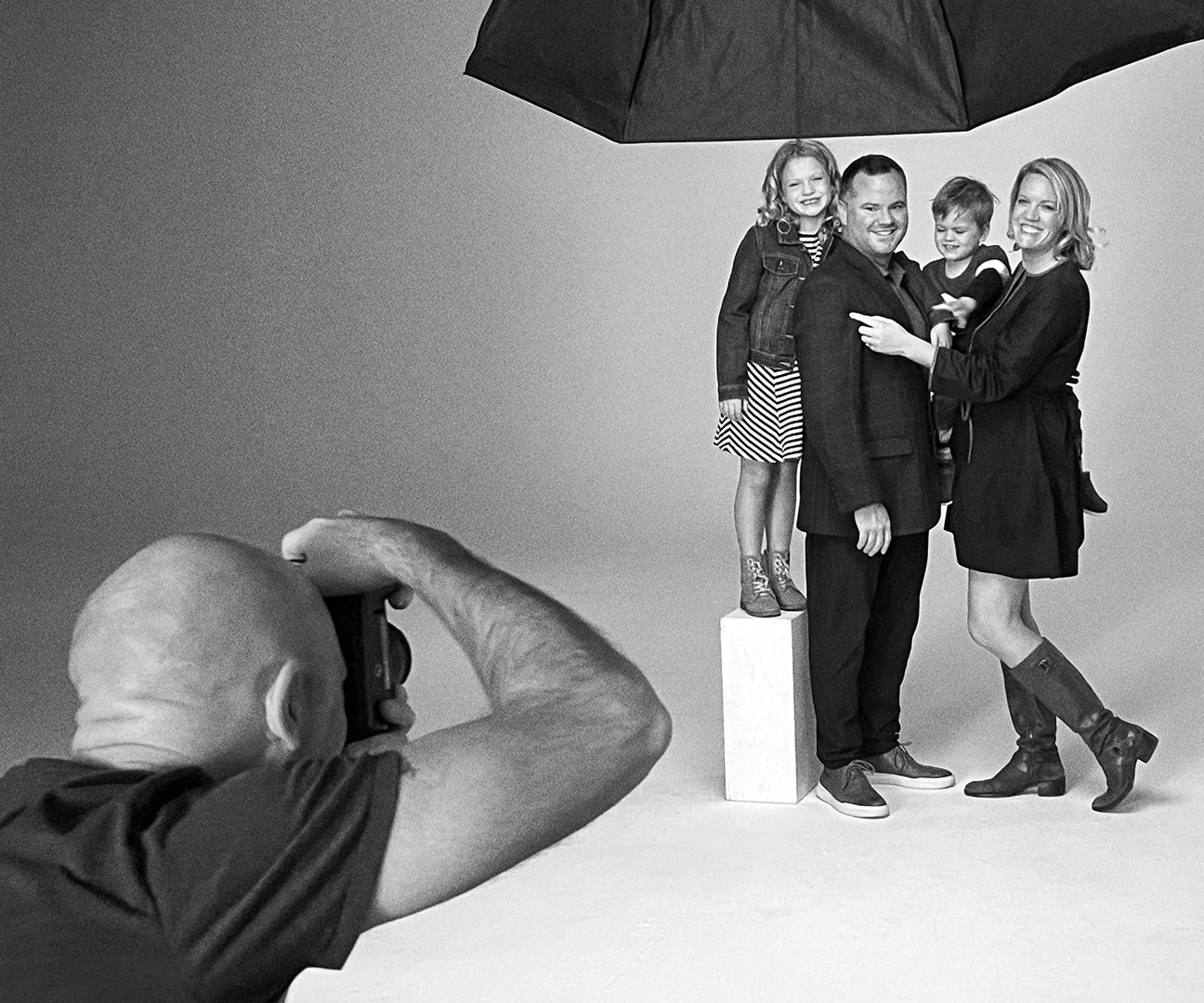 behind the scenes shot of a family having their portrait taken in the studio